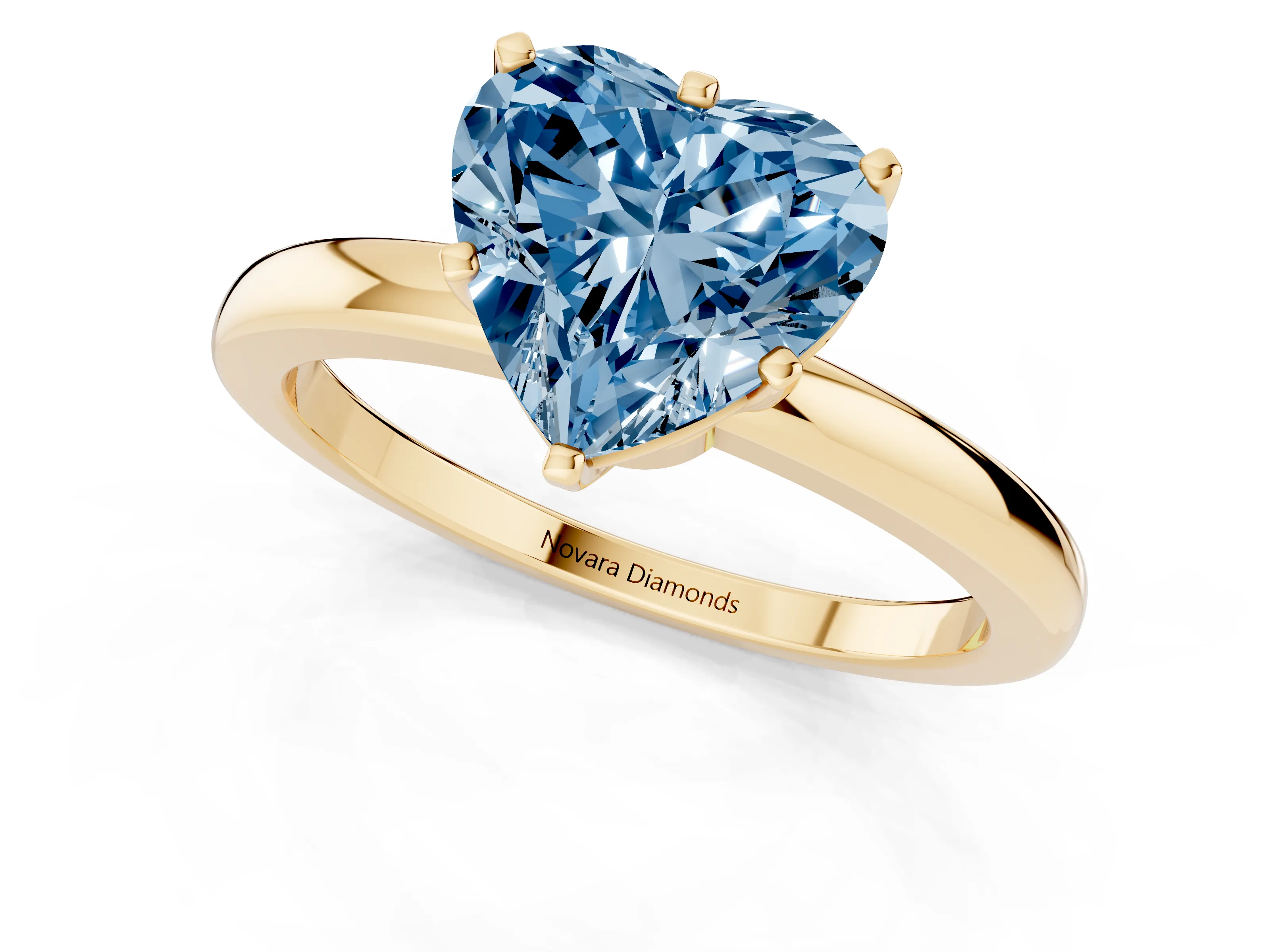 Fancy Blue Heart Cut Diamond Solitaire Ring Set in Yellow gold with Raised Prong Setting on a Classic Band