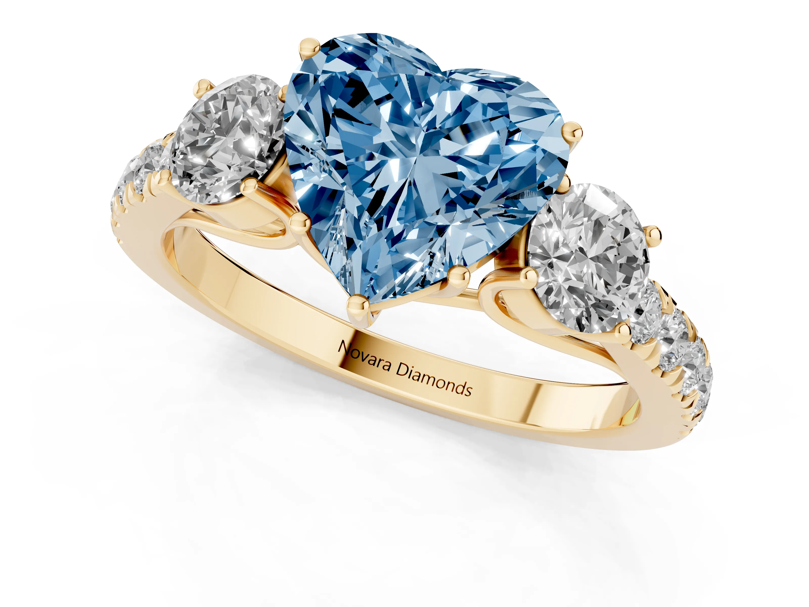 Fancy Blue Heart Cut Diamond Three-Stone Ring Set in Yellow gold with Round Side Stones and Delicate Pavé Band