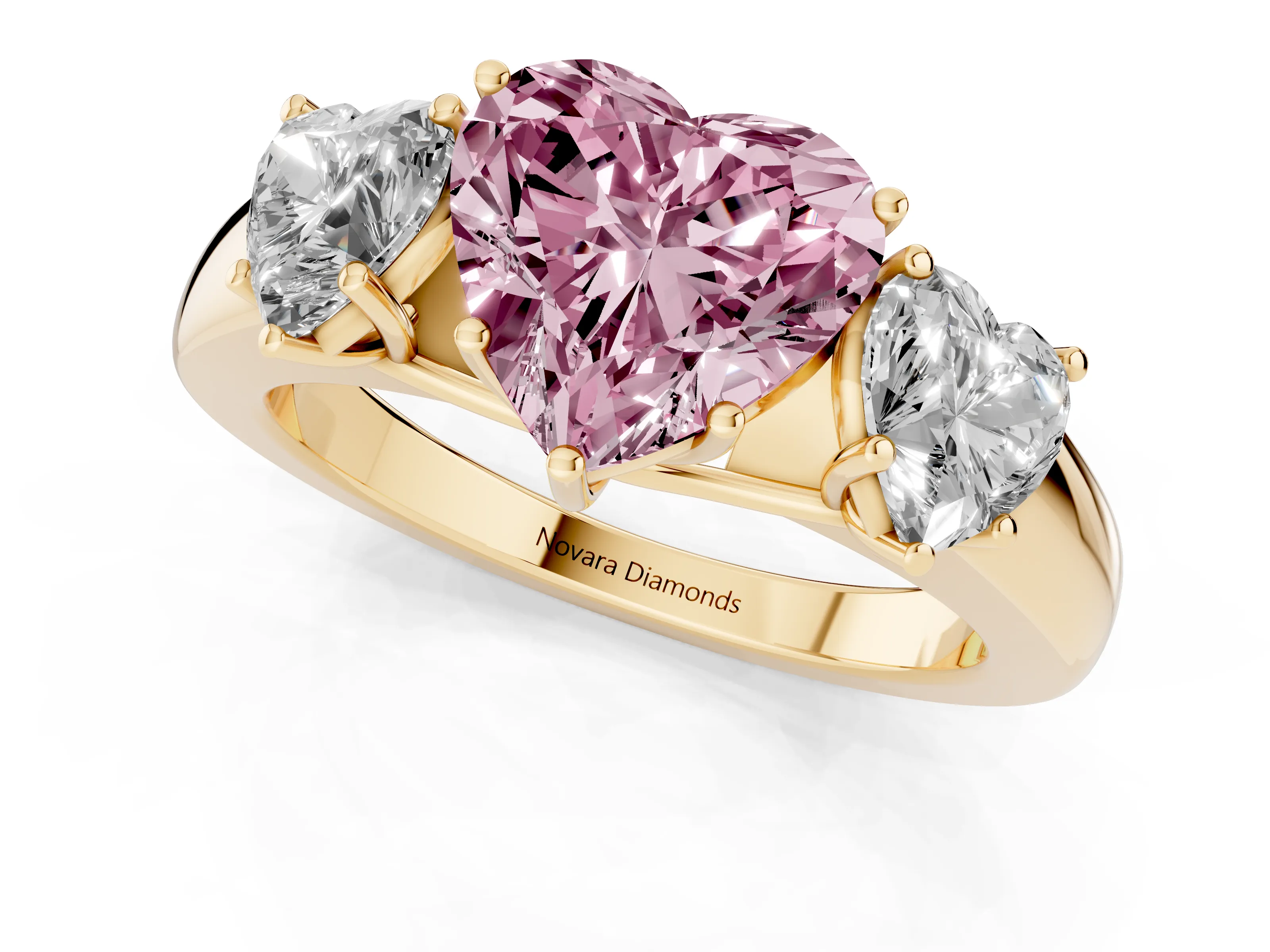 Fancy Pink Three-Stone Heart Cut Diamond Ring Set in Yellow gold with Matching Prong Settings and Plain Band