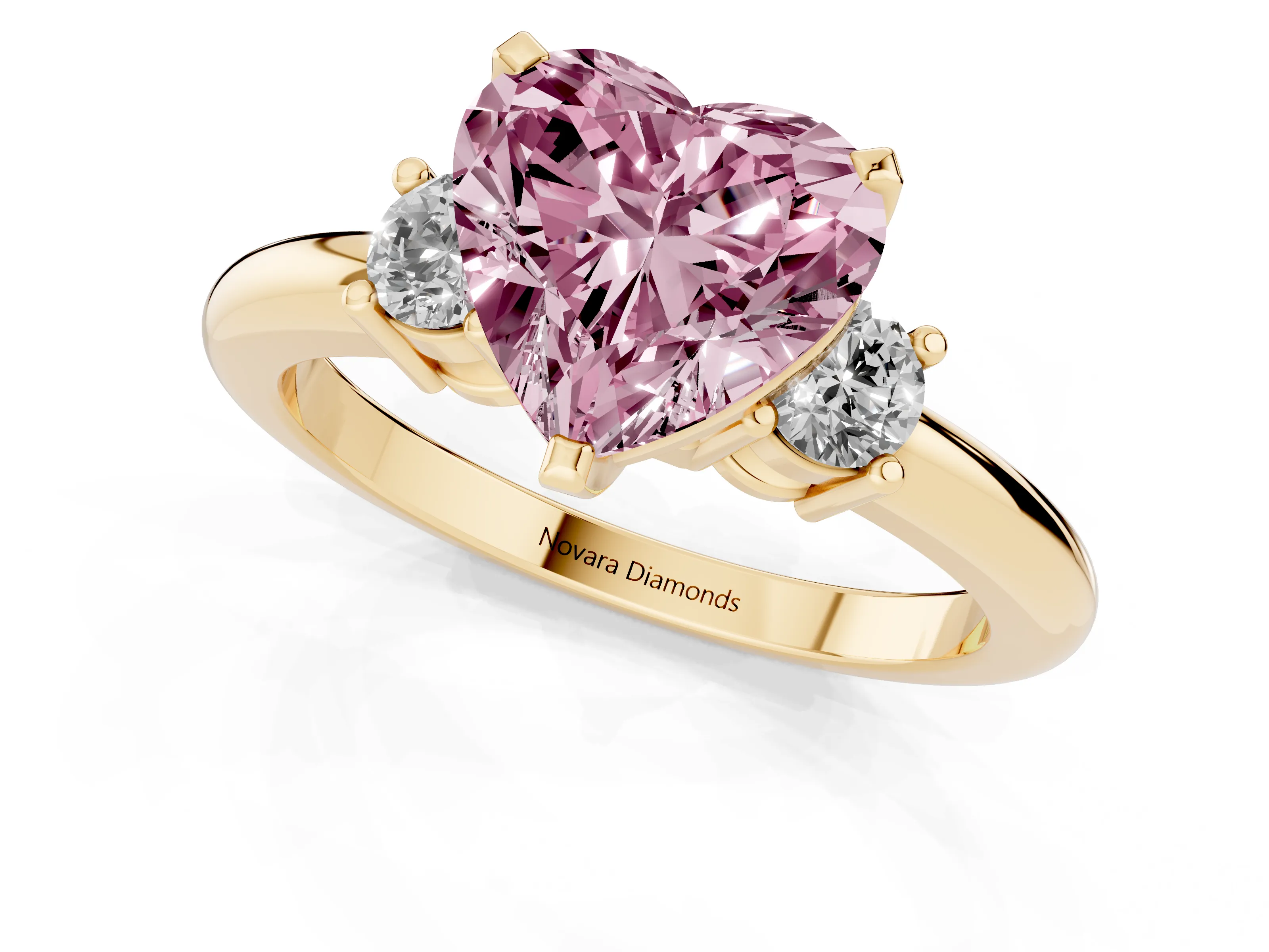 Fancy Pink Three-Stone Heart Cut Diamond Ring Set in Yellow gold with Prong Setting and Plain Band