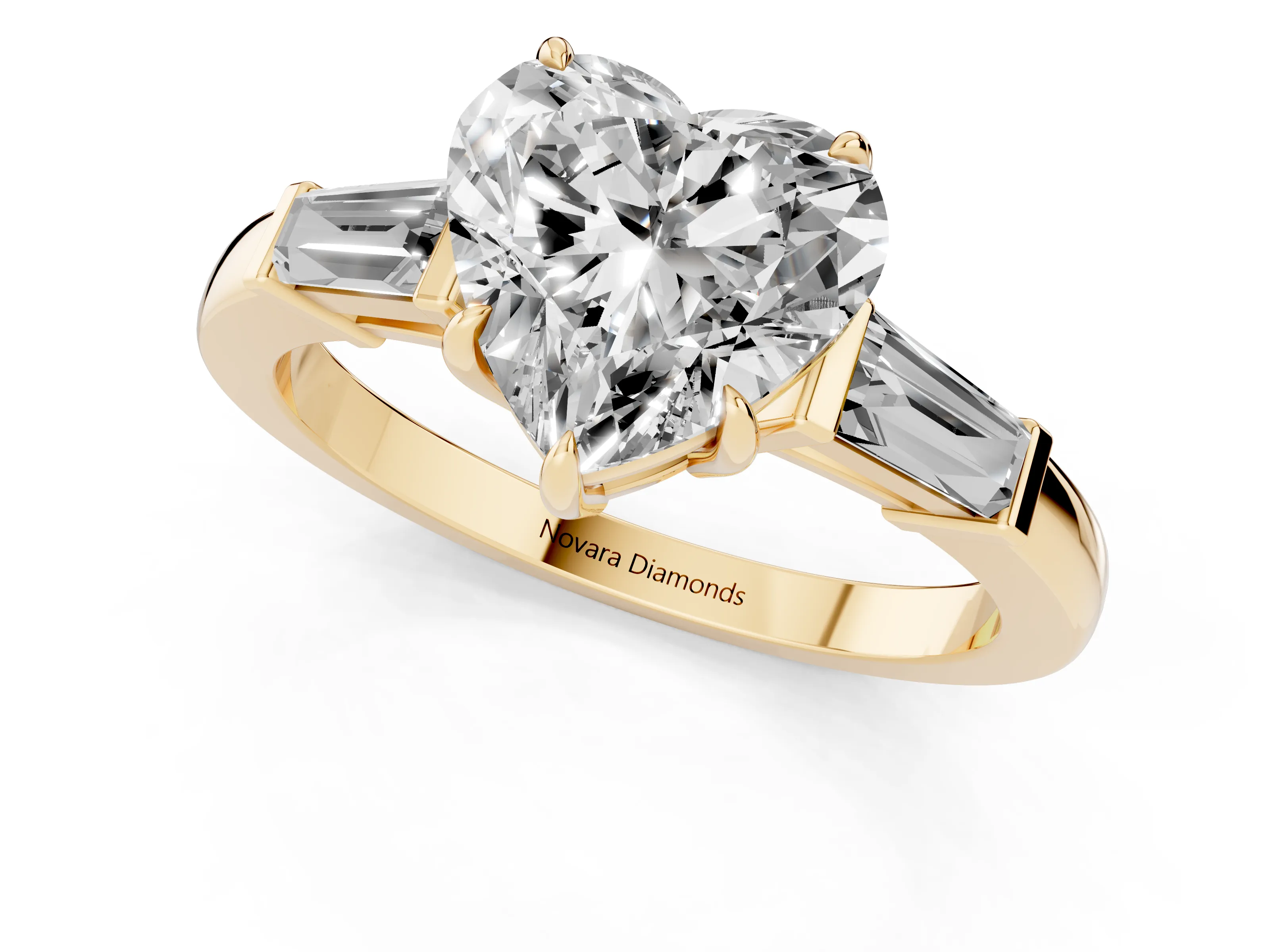 Heart Cut Diamond Three-Stone Ring Set in Yellow gold with Tapered Baguette Side Stones and Prong Setting