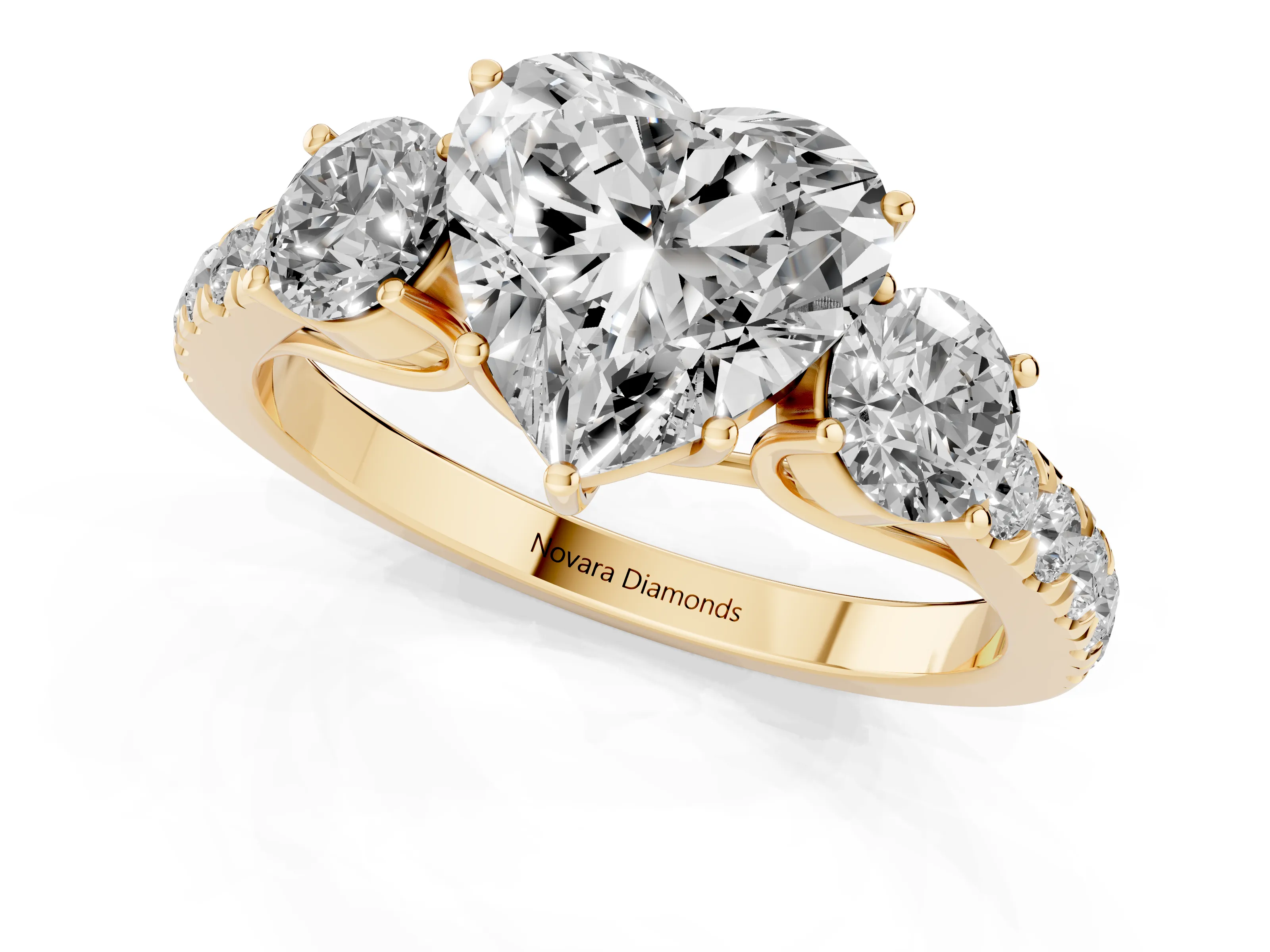 Heart Cut Diamond Three-Stone Ring Set in Yellow gold with Round Side Stones and Delicate Pavé Band