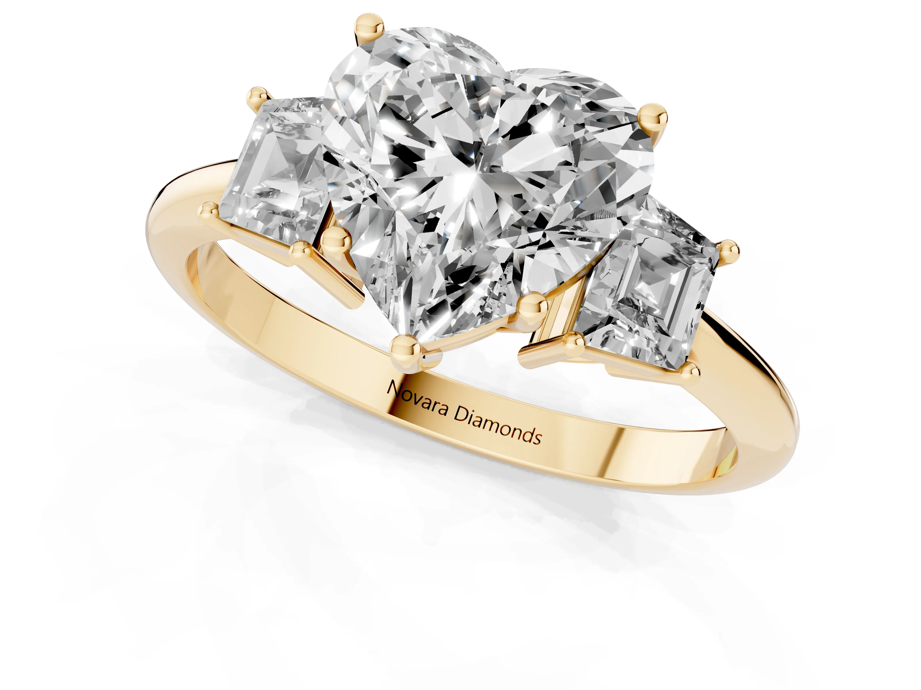 Heart Cut Diamond Three-Stone Ring Set in Yellow gold with Trapezoid Side Stones and Prong Setting