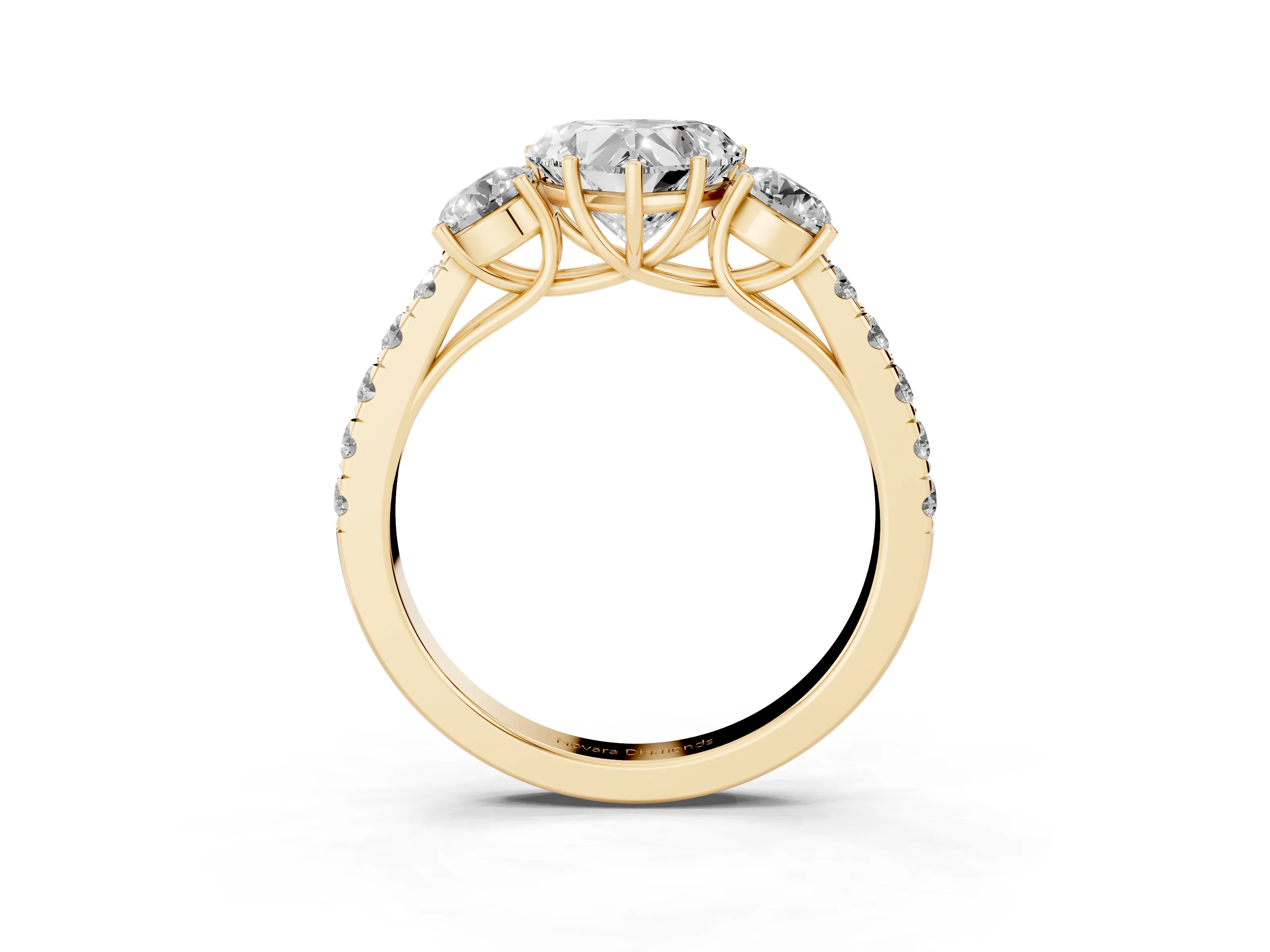 Heart Cut Diamond Three-Stone Ring Set in Yellow gold with Round Side Stones and Delicate Pavé Band